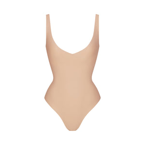 SKIMS BODY UNLINED PLUNGE THONG BODYSUIT | CLAY