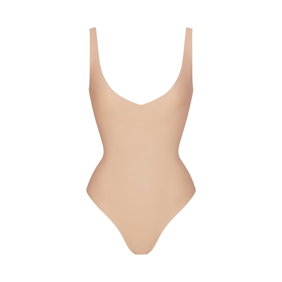 SKIMS BODY UNLINED PLUNGE THONG BODYSUIT | CLAY